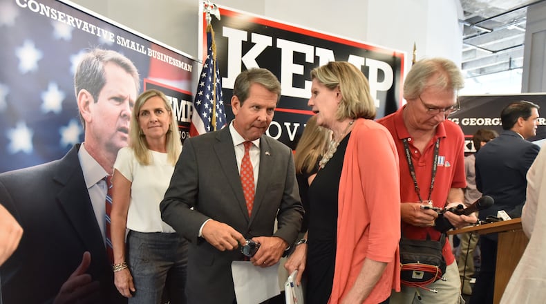 September 19, 2018 Atlanta - Republican nominee for Governor, Brian Kemp, talks with Georgia House Speaker Pro-Tem, Rep. Jan Jones after a press conference to unveil school safety plan at Brian Kemp campaign headquarters in Buckhead on Wednesday, September 19, 2018. HYOSUB SHIN / HSHIN@AJC.COM