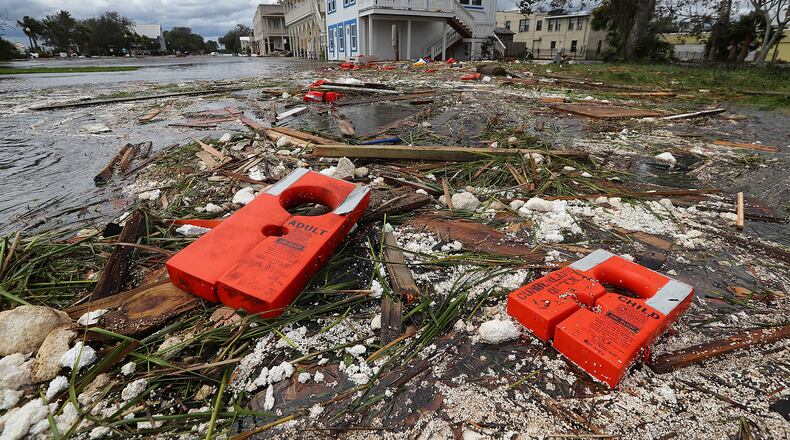Life jackets for an adult and a child are part of the debris littering the flooded main street of St. Marys after Hurricane Irma swept through the area in September. Numerous boats were destroyed after the towns docks were torn apart by the storm. Curtis Compton/ccompton@ajc.com