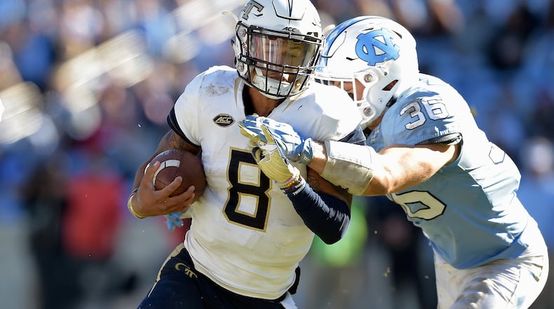 CHAPEL HILL, NC - NOVEMBER 03:  Cole Holcomb #36 of the North Carolina Tar Heels tackles Tobias Oliver #8 of the Georgia Tech Yellow Jackets during the second half of their game at Kenan Stadium on November 3, 2018 in Chapel Hill, North Carolina. Georgia Tech won 38-28.  (Photo by Grant Halverson/Getty Images)