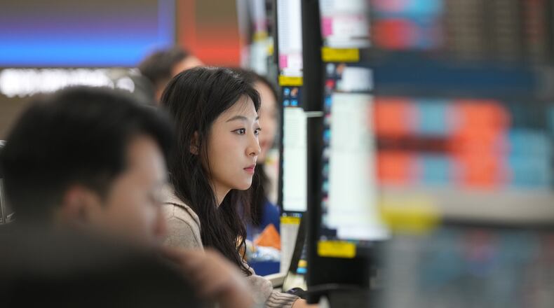 A dealer watches computer monitors at a dealing room of Hana Bank in Seoul, South Korea, Friday, May 8, 2026. (AP Photo/Lee Jin-man)