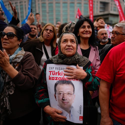 People listen to speeches during a rally in support of Istanbul's imprisoned opposition Mayor Ekrem Imamoglu as he appears for a hearing at the Caglayan courthouse, in Istanbul, Turkey, Sunday, Oct. 26, 2025. The poster with the photo of Imamoglu reads in Turkish: "Turkey will win". (AP Photo/Emrah Gurel)