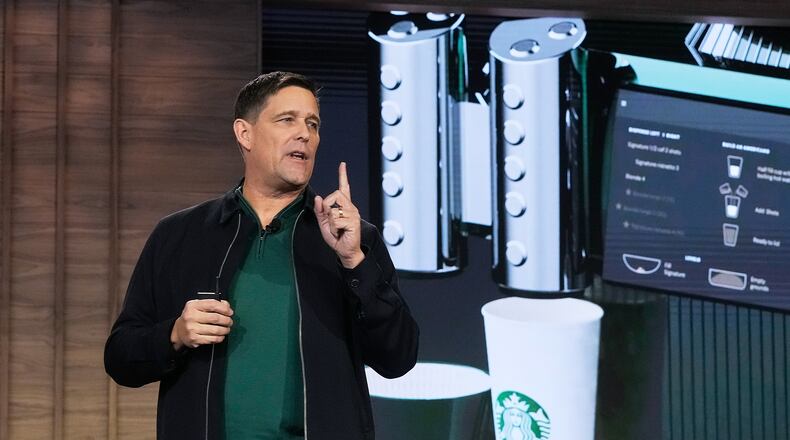 Executive Vice President and Chief Operating Officer Mike Grams speaks during the Starbucks Investor Day event, with an image of the company's Mastrena 3 espresso machine, in New York, Thursday, Jan. 29, 2026. (AP Photo/Richard Drew)