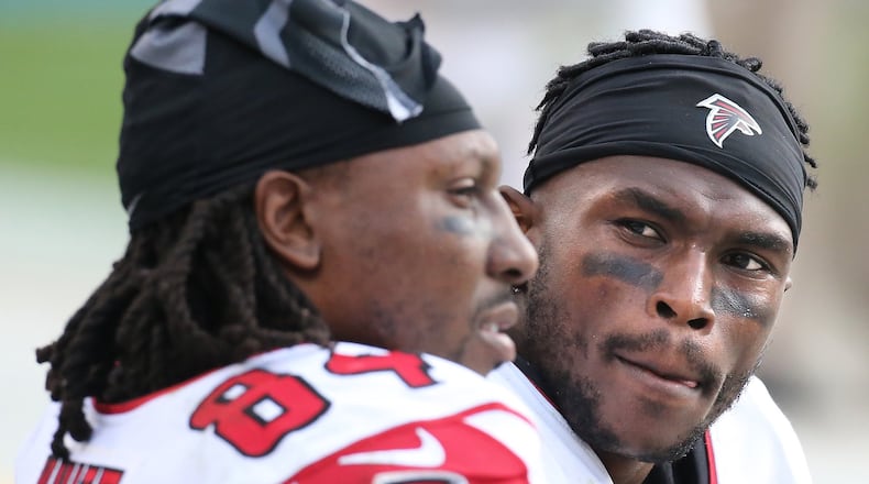 CHARLOTTE: Falcons wide receivers Roddy White and Julio Jones confer on the bench during a 38-0 loss to the Panthers in a football game on Sunday, Dec. 13, 2015, in Charlotte. Curtis Compton / ccompton@ajc.com