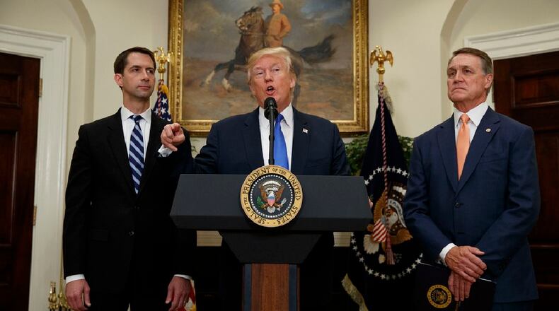 President Trump, center, with U.S. Sen. Tom Cotton, left, and U.S. Sen. David Perdue of Georgia. (AP)