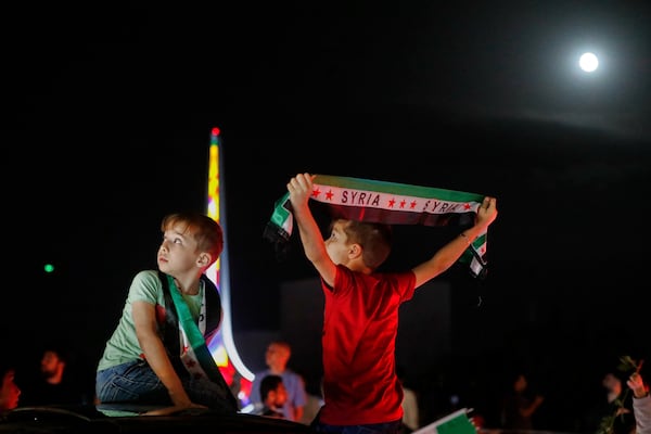 Syrians celebrate in Umayyad Square after U.S. President Donald Trump announced plans to ease sanctions on Syria and move toward normalizing relations with its new government to give the country 'a chance at peace,' in Damascus, Syria, Tuesday, May 13, 2025. (AP Photo/Omar Sanadiki)