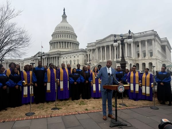 U.S. Sen. Raphael Warnock, D-Ga., and choir members from Howard University and Metropolitan Baptist University paid tribute to the late gospel artist Richard Smallwood on Wednesday in Washington. (Tia Mitchell/AJC)