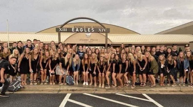 Seniors at Etowah High School in Cherokee County posed for the traditional color-coordinated senior photo on Aug, 3, 2020, the first day back to classes in the COVID era. The photo went viral because the students are not wearing masks and crowded together for the shot.