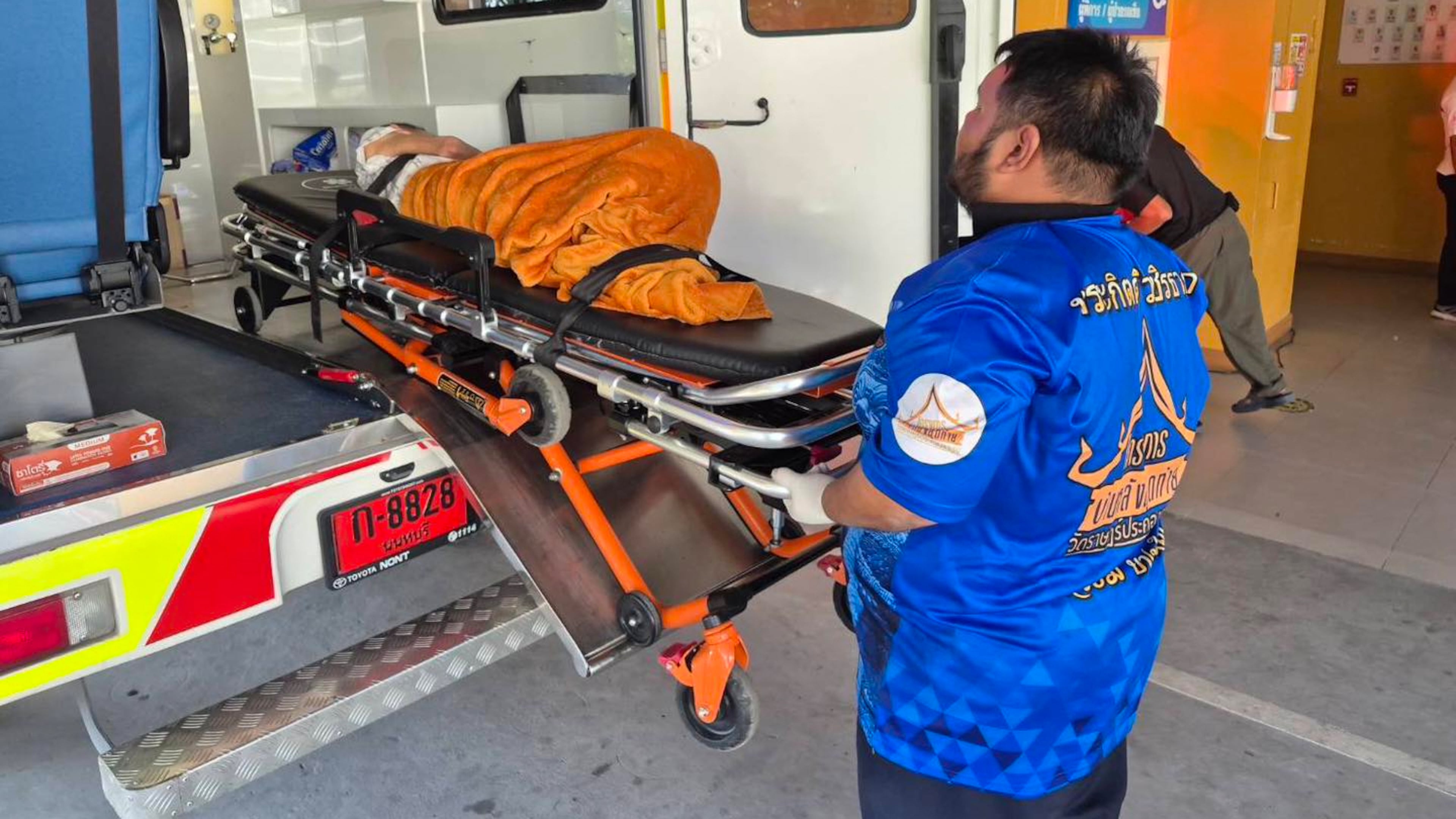 In this Sunday, Nov. 23, 2025, photo, an emergency rescue team transports an elderly woman discovered to still be alive after being considered deceased to a local hospital before her scheduled cremation at Wat Rat Prakhong Tham temple, Nonthaburi province, Thailand. (Wat Rat Prakhong Tham via AP)