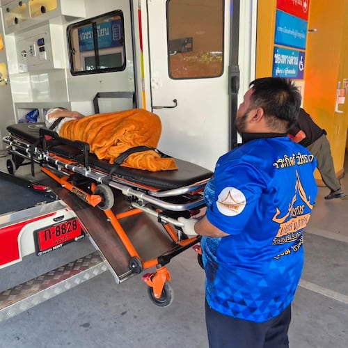 In this Sunday, Nov. 23, 2025, photo, an emergency rescue team transports an elderly woman discovered to still be alive after being considered deceased to a local hospital before her scheduled cremation at Wat Rat Prakhong Tham temple, Nonthaburi province, Thailand. (Wat Rat Prakhong Tham via AP)