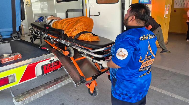 In this Sunday, Nov. 23, 2025, photo, an emergency rescue team transports an elderly woman discovered to still be alive after being considered deceased to a local hospital before her scheduled cremation at Wat Rat Prakhong Tham temple, Nonthaburi province, Thailand. (Wat Rat Prakhong Tham via AP)