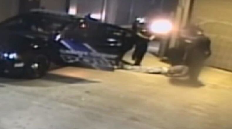 Surveillance footage shows officers pull Wayman Keller Jr. from the back seat of a patrol car. A nurse refused to give the drug suspect aid. (Credit: Channel 2 Action News)