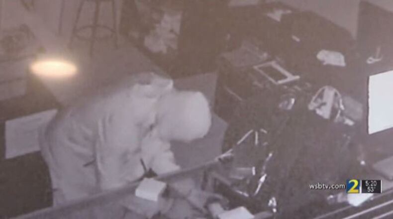 The man threw a massive rock through the front door of the store.