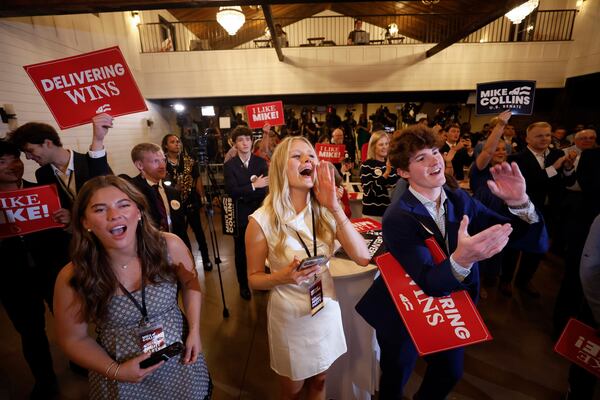 Supporters of U.S. Rep. Mike Collins cheer as they watch him speak on stage during the runoff election watch party at Seven Oaks Manor in Jackson, GA, on Tuesday, June 16, 2026.   (Miguel Martinez/AJC)
