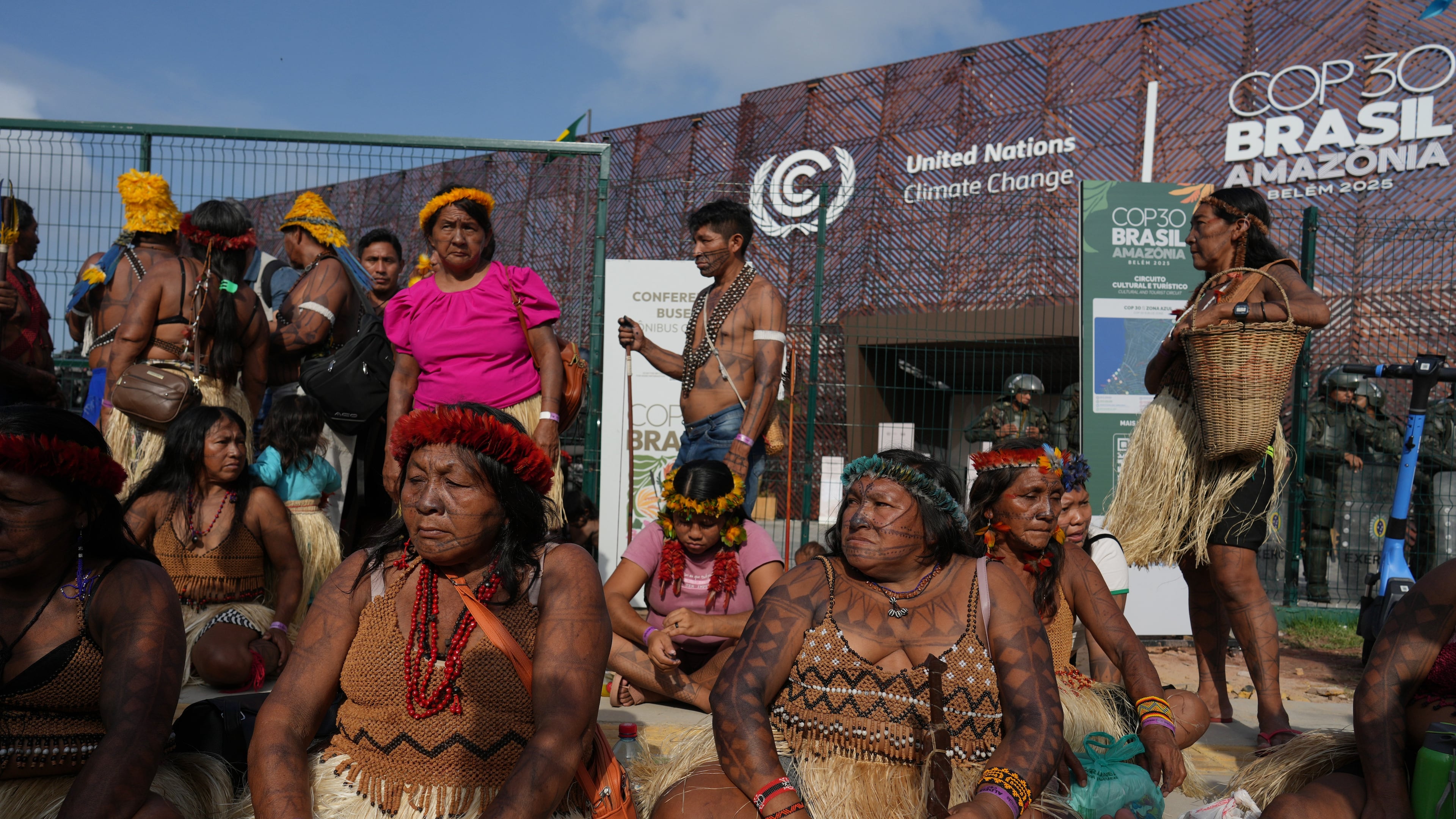 An Indigenous group blocks an entrance to the COP30 U.N. Climate Summit, Friday, Nov. 14, 2025, in Belem, Brazil. (AP Photo/Andre Penner)