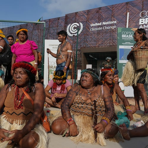 An Indigenous group blocks an entrance to the COP30 U.N. Climate Summit, Friday, Nov. 14, 2025, in Belem, Brazil. (AP Photo/Andre Penner)