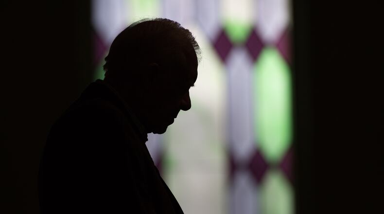 Former President Jimmy Carter prays during Sunday School class at Maranatha Baptist Church in Plains, Ga., in 2015. Carter was a lifelong Sunday school teacher and drew thousands from around the world to his tiny hometown to listen to him. (AP Photo/Branden Camp)