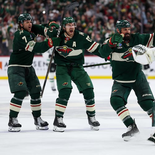 Minnesota Wild players celebrate after their team's win over the Dallas Stars during overtime of Game 4 in the first round of the NHL Stanley Cup hockey playoffs Saturday, April 25, 2026, in St. Paul, Minn. (AP Photo/Matt Krohn)