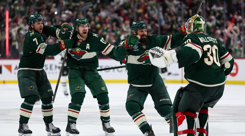 Minnesota Wild players celebrate after their team's win over the Dallas Stars during overtime of Game 4 in the first round of the NHL Stanley Cup hockey playoffs Saturday, April 25, 2026, in St. Paul, Minn. (AP Photo/Matt Krohn)