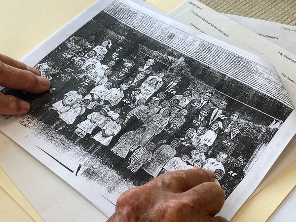 The Rewis family made up a large percentage of the Echols County population in the early 20th century. Austin DeLoach points out Rewises in this school photo from 1916. (Adam Van Brimmer/adam.vanbrimmer@ajc.com)