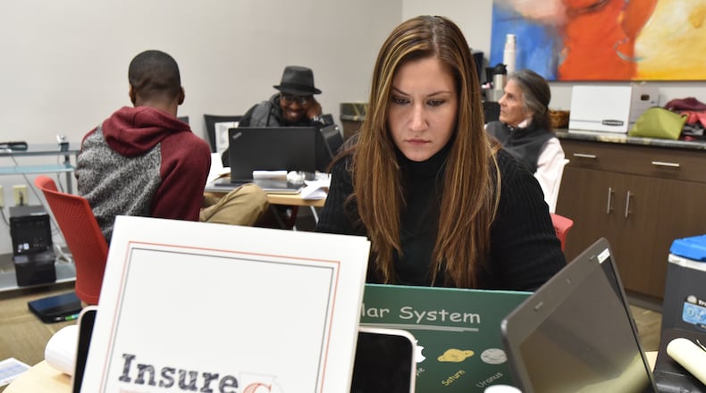 Ursula Spence, navigator, uses her laptop to study a sample case during their meeting prior to an Open Enrollment for the Affordable Care Act/Obamacare held by Insure Georgia, in Macon on Thursday, October 26, 2017.