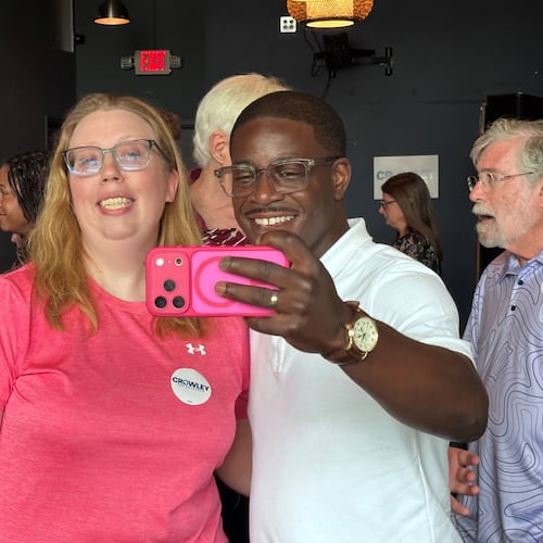 David Crowley, Democratic candidate for Wisconsin governor, takes a selfie photo with supporter Abigail Tessmann during a campaign stop Wednesday, Aug. 5, 2026, in Madison, Wis. (AP Photo/Scott Bauer)