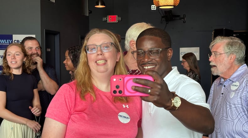 David Crowley, Democratic candidate for Wisconsin governor, takes a selfie photo with supporter Abigail Tessmann during a campaign stop Wednesday, Aug. 5, 2026, in Madison, Wis. (AP Photo/Scott Bauer)