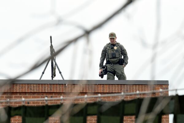 A law enforcement officer keeps watch from a rooftop overlooking the Boulder Jewish Festival in Boulder, Colo., on Sunday, June 8, 2025. (AP Photo/Thomas Peipert)