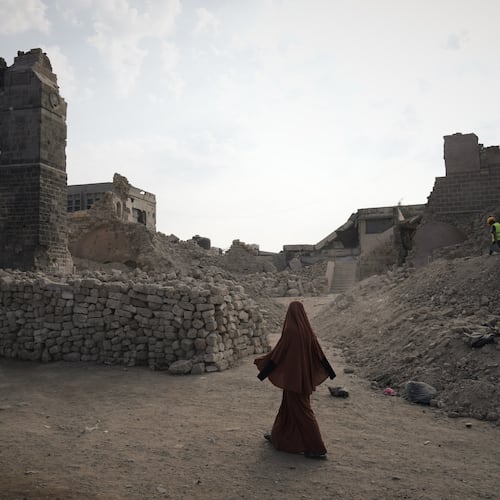 A Palestinian woman walks past the historic Pasha Palace in Gaza City after an Israeli airstrike badly damaged the building during the war in the Gaza Strip, Thursday, Nov. 13, 2025. (AP Photo/Jehad Alshrafi)