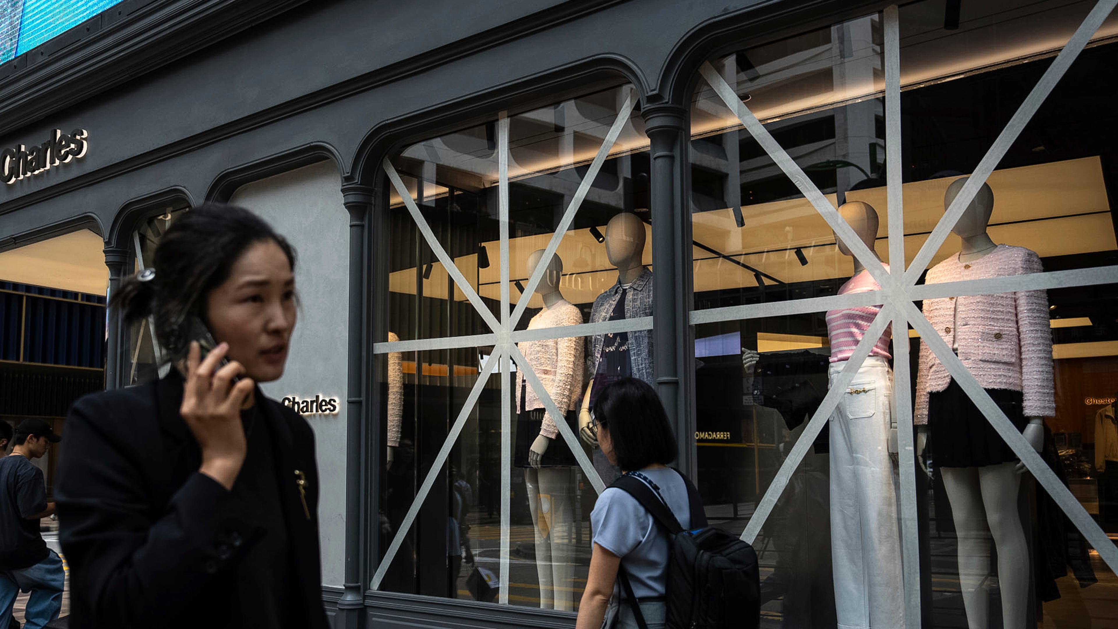 Taped-up windows are seen at a retail store ahead of Super Typhoon Ragasa approaches Hong Kong, Tuesday, Sept. 23, 2025. (AP Photo/Chan Long Hei)