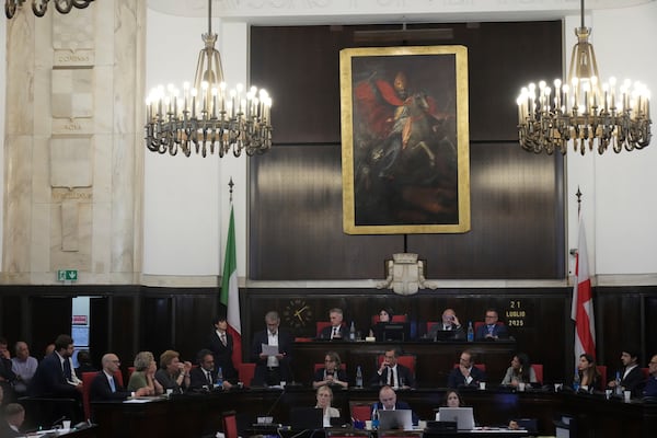 Milan's Councillor for Urban Regeneration, Giancarlo Tancredi, center left, delivers his speech in the City Council Monday, July 21, 2025, in Milan, northern Italy, as prosecutors are investigating more than 70 individuals, including Mayor Sala and Tancredi, over a sprawling corruption probe into the city's real estate industry. (AP Photo/Antonio Calanni)