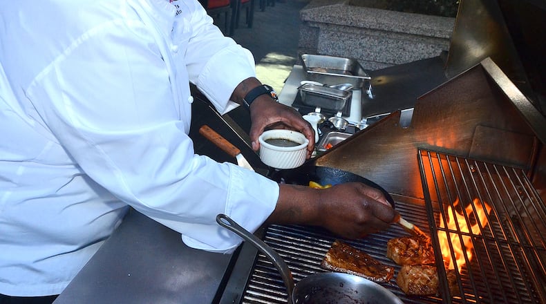 Chef Tonya Morris prepares and grills fresh cobia with black rice and sauteed tomatoes/ Photo by Chris Hunt