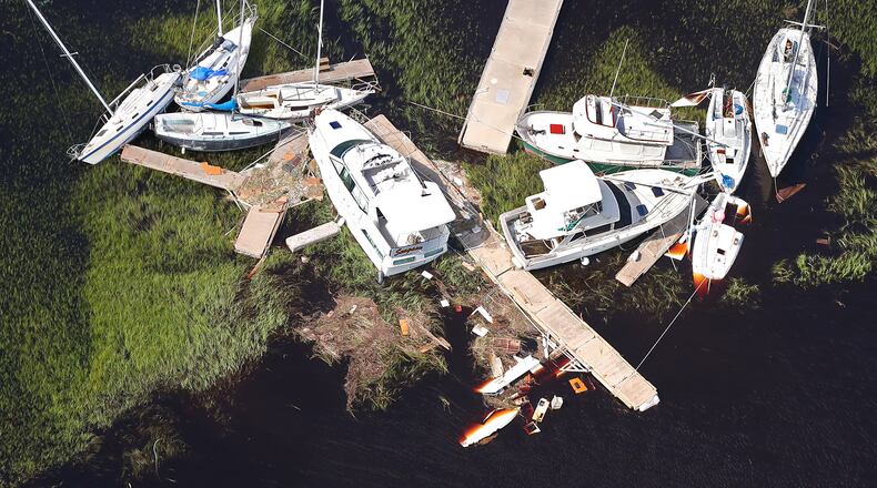 Boats along with sections of dock are scattered in the marsh, some sitting on the bottom, after Hurricane Irma on Tuesday at St. Marys on the Georgia coast. Curtis Compton/ccompton@ajc.com