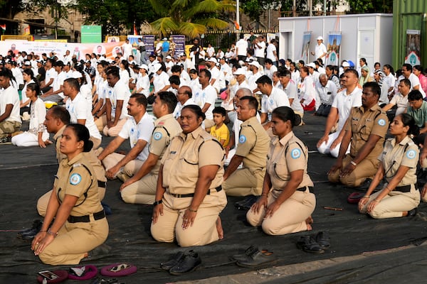 Security personal perform yoga on International Yoga Day in Mumbai, India, Saturday, June 21, 2025. (AP Photo/Rajanish Kakade)