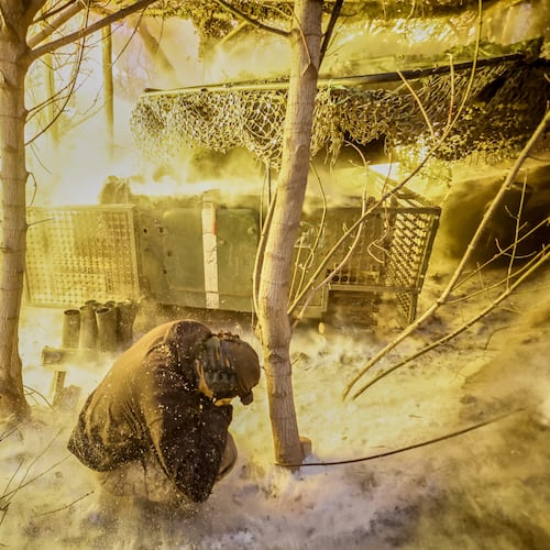 In this photo provided by Ukraine's 24th Mechanized Brigade press service, servicemen fire a 2S1 Gvozdika self propelled howitzer towards Russian positions near Chasiv Yar town, Donetsk region, Ukraine, Sunday, Jan. 18, 2026. (Oleg Petrasiuk/Ukraine's 24th Mechanized Brigade via AP)