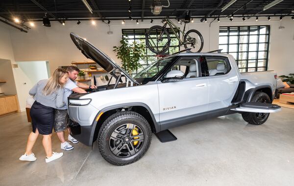 Christian and Katana Brunkow check out the front trunk of a Rivian R1T in the new Rivian “space” at Avalon in Alpharetta on Friday, April 4, 2025. 
(Bita Honarvar for The Atlanta Journal-Constitution)