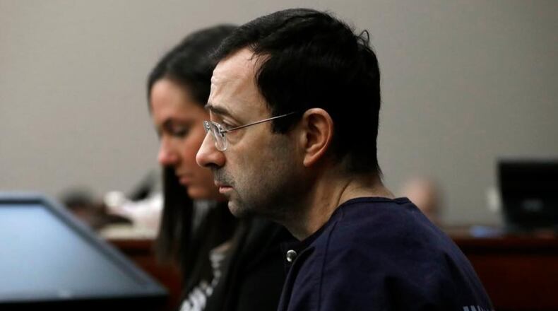 Dr. Larry Nassar listens as a victim gives her impact statement during the seventh day of his sentencing hearing Wednesday, Jan. 24, 2018, in Lansing, Mich. Nassar has admitted sexually assaulting athletes when he was employed by Michigan State University and USA Gymnastics, which is the sport's national governing organization and trains Olympians. (AP Photo/Carlos Osorio)