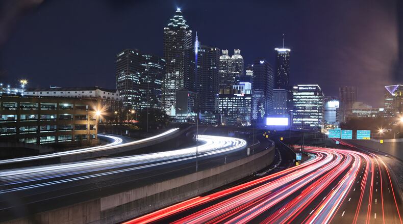 STREAKING DOWNTOWN--Feb. 14, 2014 Atlanta: Streaks of tail lights and headlights from Atlanta commuters on the downtown connector shows the free flowing traffic in this time exposure Friday, Feb. 14, 2014. Early commuters found Friday's predawn drive icy and dicey and in one instance deadly but the reports of icing slowed after daybreak, as bright sunshine helped melt the black ice scattered across metro Atlanta. "We think we're ahead of this now," said Georgia Department of Transportation spokeswoman Karlene Barron. "This is pretty much behind us." Channel 2 meteorologist Karen Minton said Saturday should be mostly sunny, with morning lows around 32 and afternoon highs in the mid-40s. The sunny skies will continue through Sunday, when lows will again be in the low 30s and afternoon highs will reach the mid-50s. JOHN SPINK/JSPINK@AJC.COM