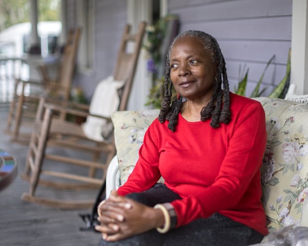 Anita Collins, a Brunswick resident and chairwoman of the Urbana-Perry Park Neighborhood Planning Assembly, sits on her front porch on Jan. 16, 2024. Collins grew up two blocks from the now-shuttered Hercules Inc. factory that produced the toxic pesticide toxaphene and now leads the NPA for the area surrounding the site. (Stephen B. Morton/AJC Photo)