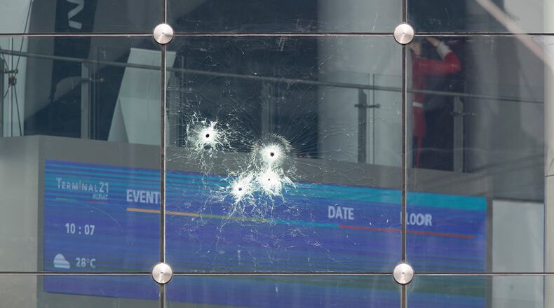 Bullet holes mark the glass wall of the Terminal 21 Korat mall in Nakhon Ratchasima, Thailand. Thai officials say a soldier who went on a shooting rampage and killed numerous people and injured dozens of others has been shot dead inside a mall in northeastern Thailand.