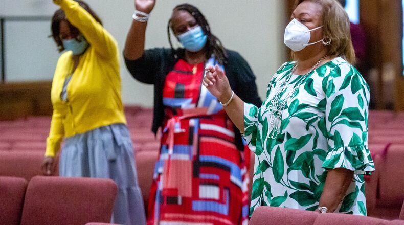 Miranda McKenzie (right) participates in Sunday's service at the Greater Piney Grove Baptist Church in Atlanta on Aug. 29, 2021. (Steve Schaefer for The Atlanta Journal-Constitution)