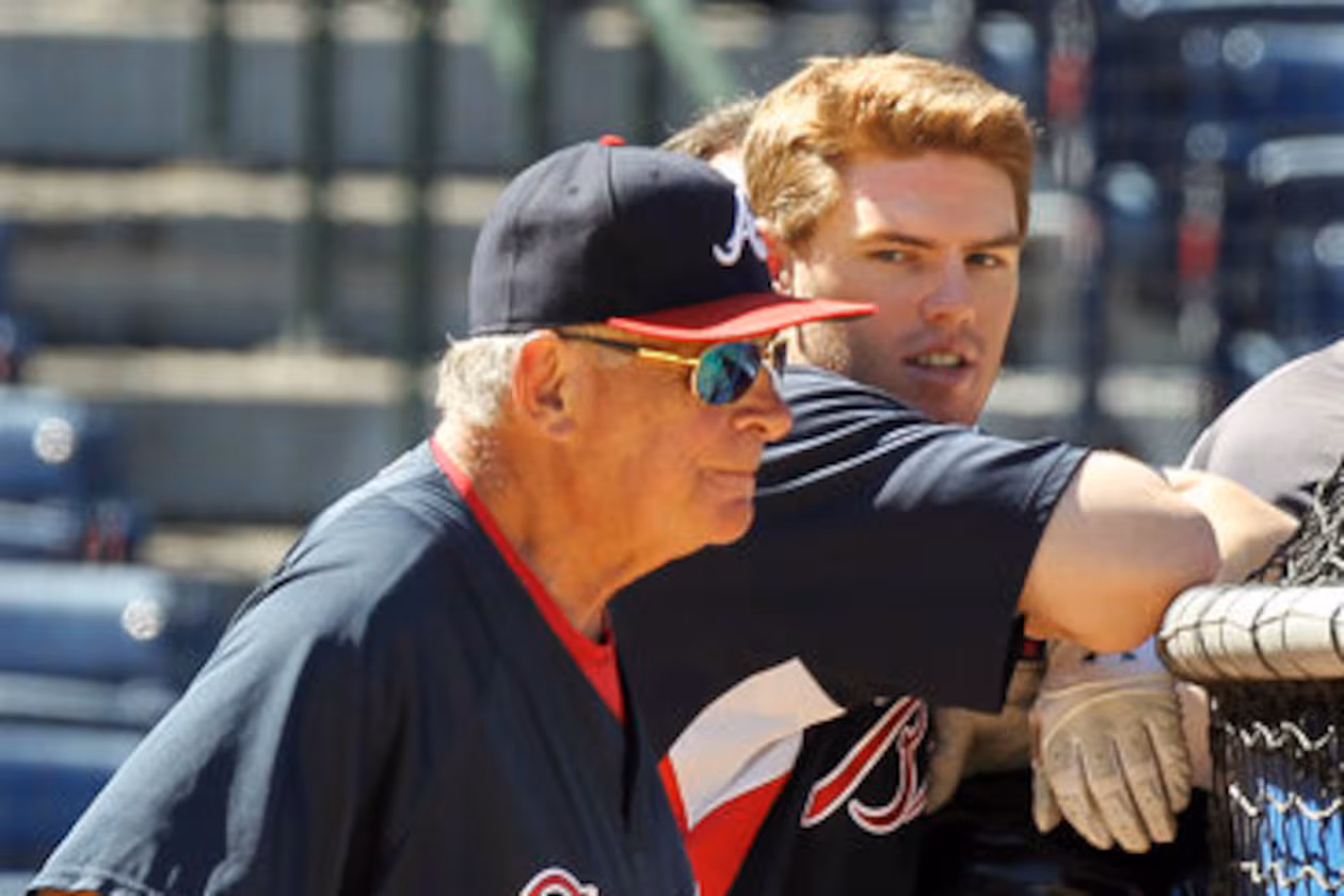 Bobby Cox and rookie Freddie Freeman take in batting practice. (AJC File)