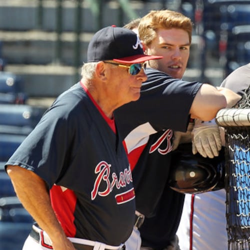 Bobby Cox and rookie Freddie Freeman take in batting practice. (AJC File)
