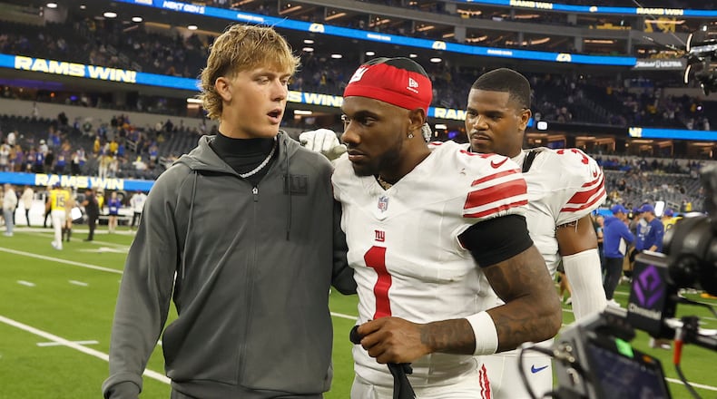 New York Giants quarterback Jaxson Dart, left, walks off the field with wide receiver Malik Nabers (1) after an NFL football game against the Los Angeles Rams in Inglewood, Calif., Monday, Sept. 21, 2026. (AP Photo/Caroline Brehman)