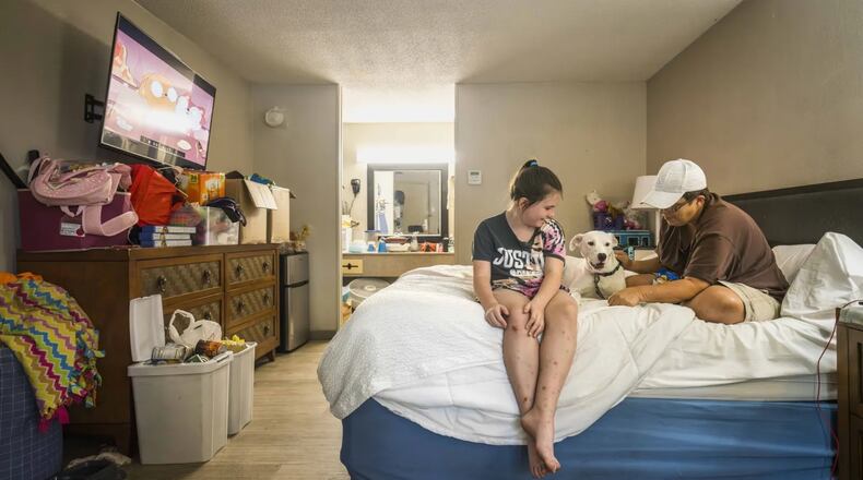 Melissa Bullard (right) with her daughter Heaven and their dog in the bed at the Days Inn in Brunswick, Georgia, Friday, Sept. 6, 2024. (Photo Courtesy of Justin Taylor/The Current GA)