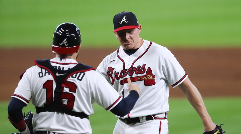 Braves closer Mark Melancon and catcher Travis d’Arnaud celebrate closing out 9-5 win over the Miami Marlins in Game 1 of the National League Division Series Tuesday, Oct 6, 2020, at Minute Maid Park in Houston. (Curtis Compton / Curtis.Compton@ajc.com)