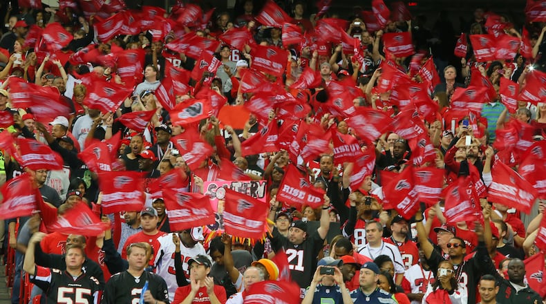 Falcons fans wave "Rise Up" flags in a frenzy during the first quarter of their playoff game against the Seahawks on Jan. 13, 2013.