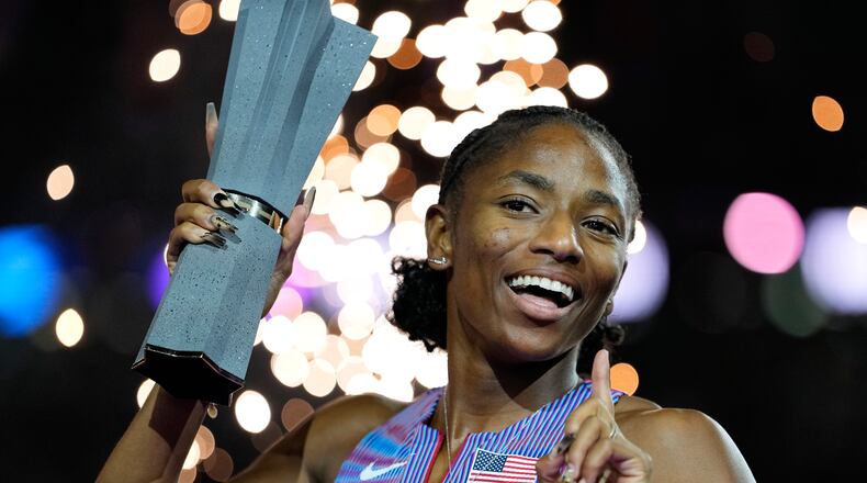 Melissa Jefferson-Wooden, of the United States, poses with her trophy after winning the women's 200 meters final at the World Athletics Ultimate Championship in Budapest, Hungary, Sunday, Sept. 13, 2026. (AP Photo/Matthias Schrader)