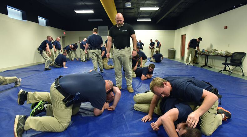 May 6, 2015: Jim Koury (standing) instructs officers during basic training at the public safety training center in Canton. HYOSUB SHIN / HSHIN@AJC.COM