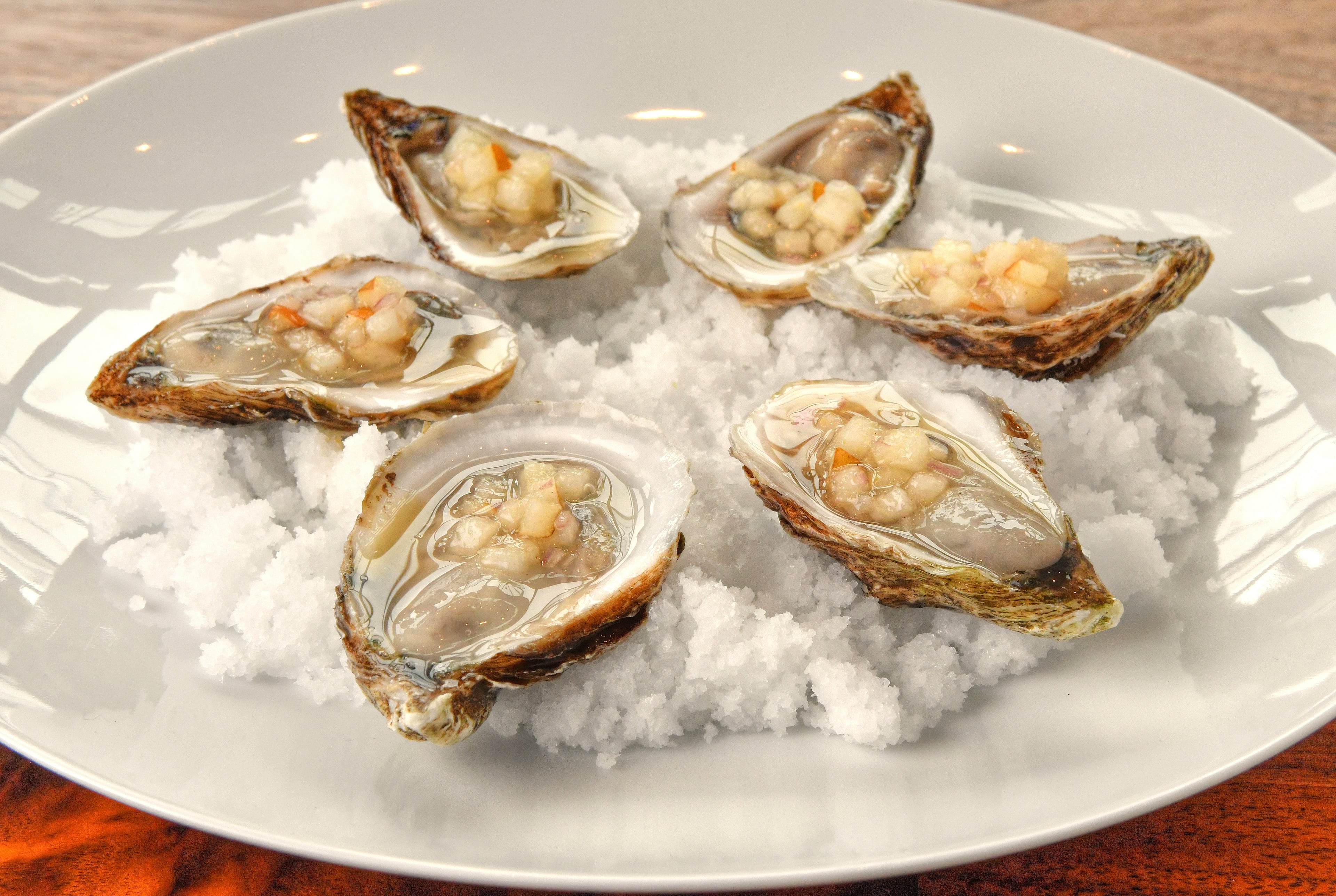 In a 2022 restaurant review for Lucian Books & Wine, former dining critic Wendell Brock said described the oysters as "so subtly dressed they almost appear naked." (Chris Hunt for The Atlanta Journal-Constitution)