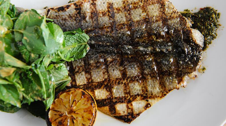Wood Grilled Branzino with charmoula, seven herb salad, charred lemon at Drift. (BECKY STEIN PHOTOGRAPHY)